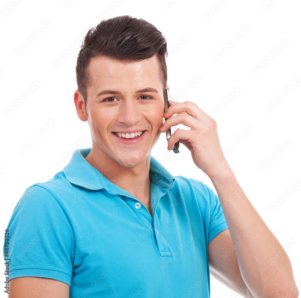 young casual man speaking on cellphone young casual man speaking on cellphone