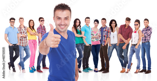 man making the ok thumbs up gesture in front of his firends