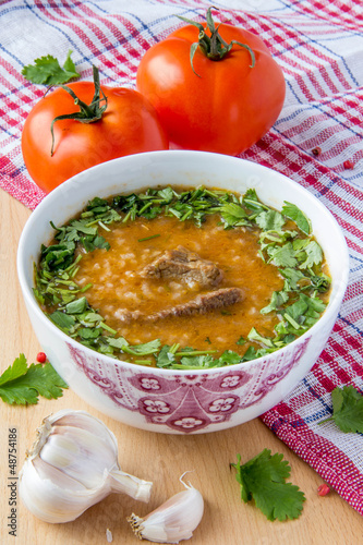 Oriental tomato soup with meat, rice and cilantro