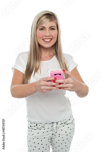 Gorgeous girl messaging her friends from cellphone
