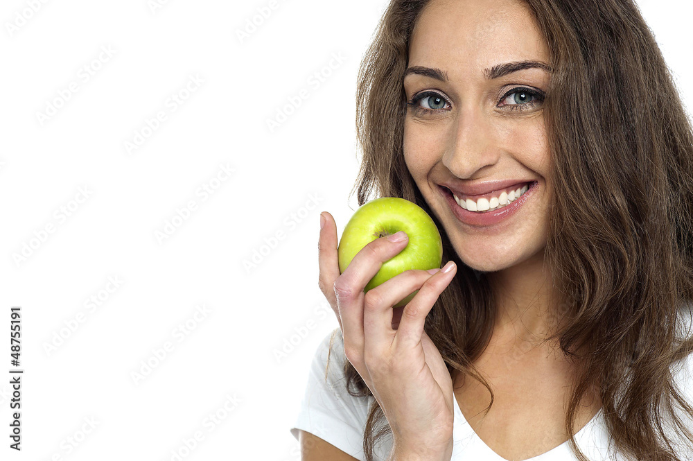 Health conscious woman about to eat fresh green apple Health conscious woman about to eat fresh green apple