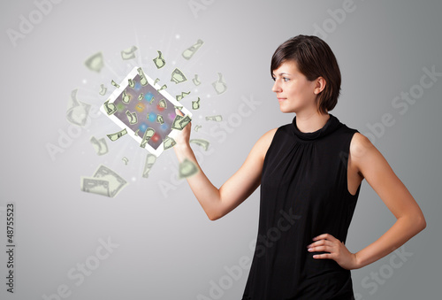 Fototapeta Naklejka Na Ścianę i Meble -  young woman holding tablet with money