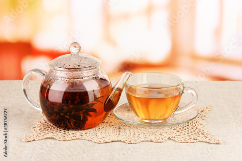 Exotic green tea with flowers in glass teapot