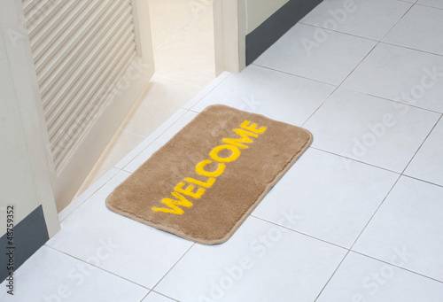 Welcome doormat in front of the rest room