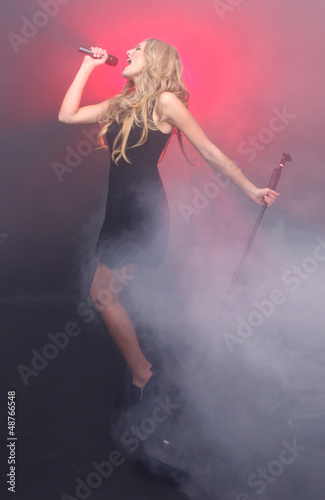 Beautiful Blonde Rock Star on Stage Singing