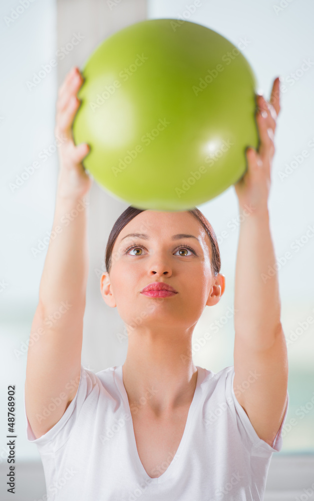 Portrait of fit and healthy woman with toning ball at fitness cl Portrait of fit and healthy woman with toning ball at fitness cl