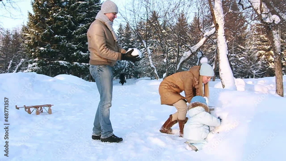 Young family throw up snow in the Air (SLOW)