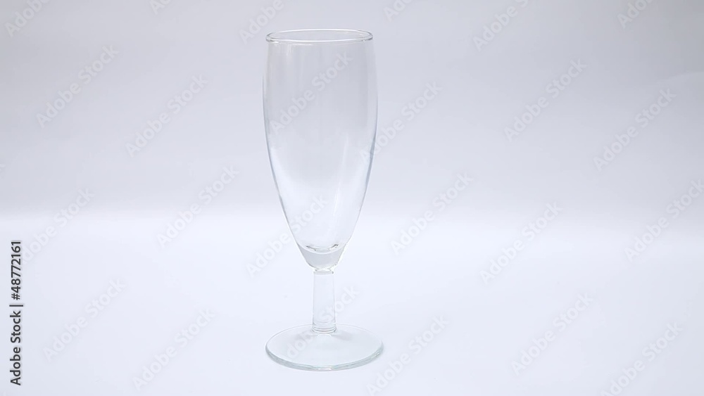 Pouring white sparkling wine into the wine glass Pouring white sparkling wine into the wine glass