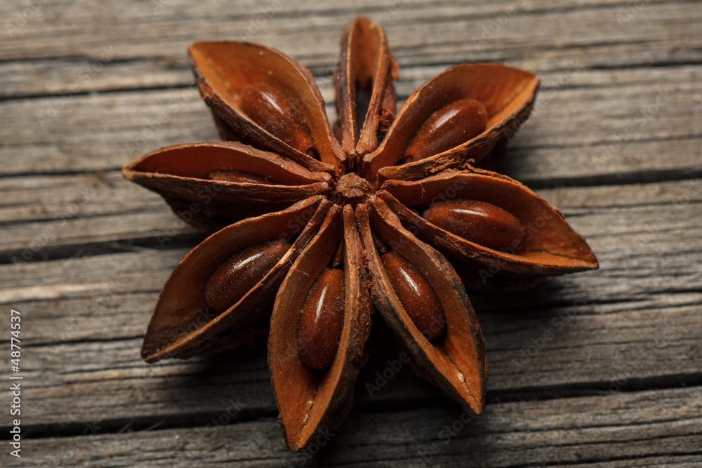 Close-up of anise star on wooden texture. Close-up of anise star on wooden texture.