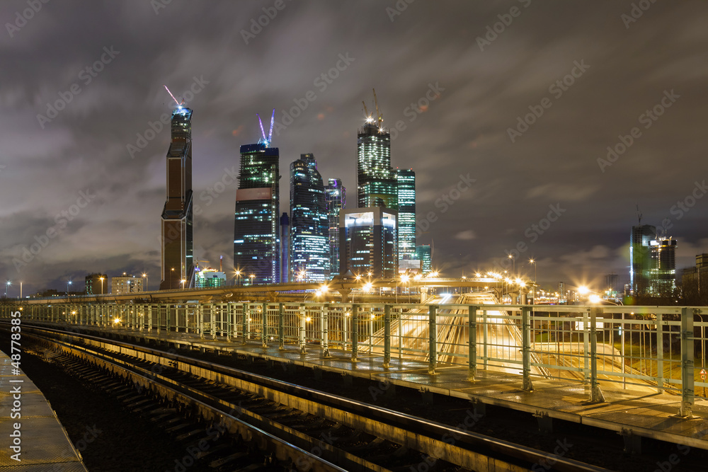 Night railroad and skyscrapers