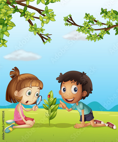 A smiling girl with magnifier and a boy