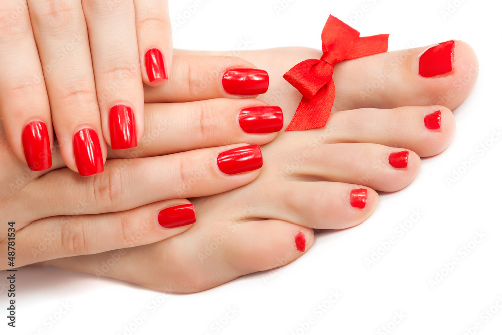Relaxing Red manicure and pedicure with a bow. isolated Relaxing Red manicure and pedicure with a bow. isolated