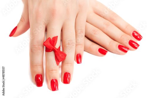  red manicure with a bow isolated