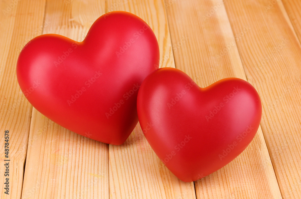 Decorative red hearts close-up on wooden table