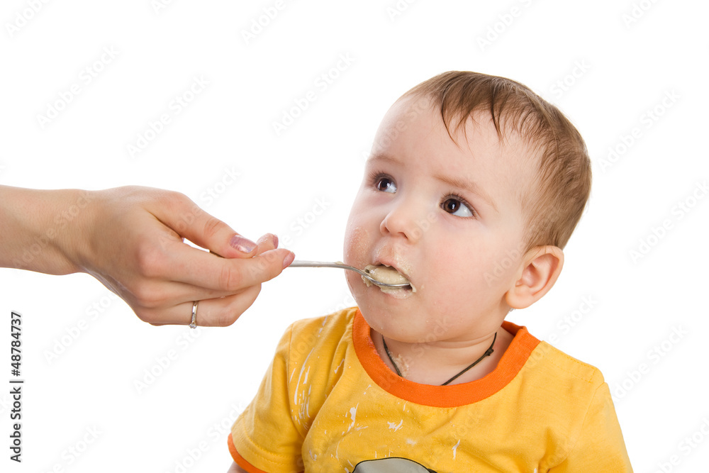 mother feeding her baby by spoon. isolated on white mother feeding her baby by spoon. isolated on white