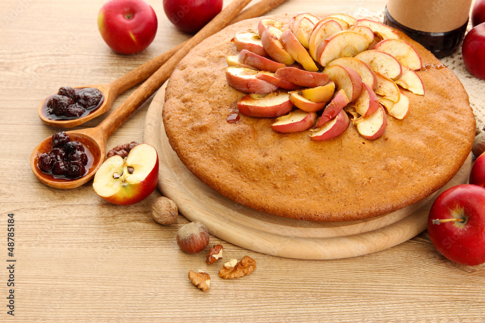 tasty homemade pie with apples and jam, on wooden table