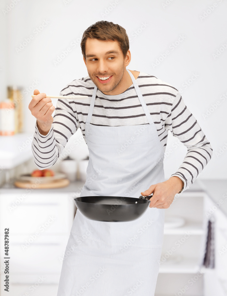 handsome man with pan at kitchen handsome man with pan at kitchen