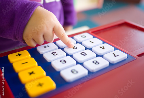 kids finger pressing toy calculator