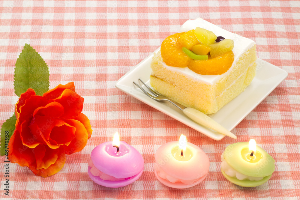 artificial rose and fruit cake and candles artificial rose and fruit cake and candles