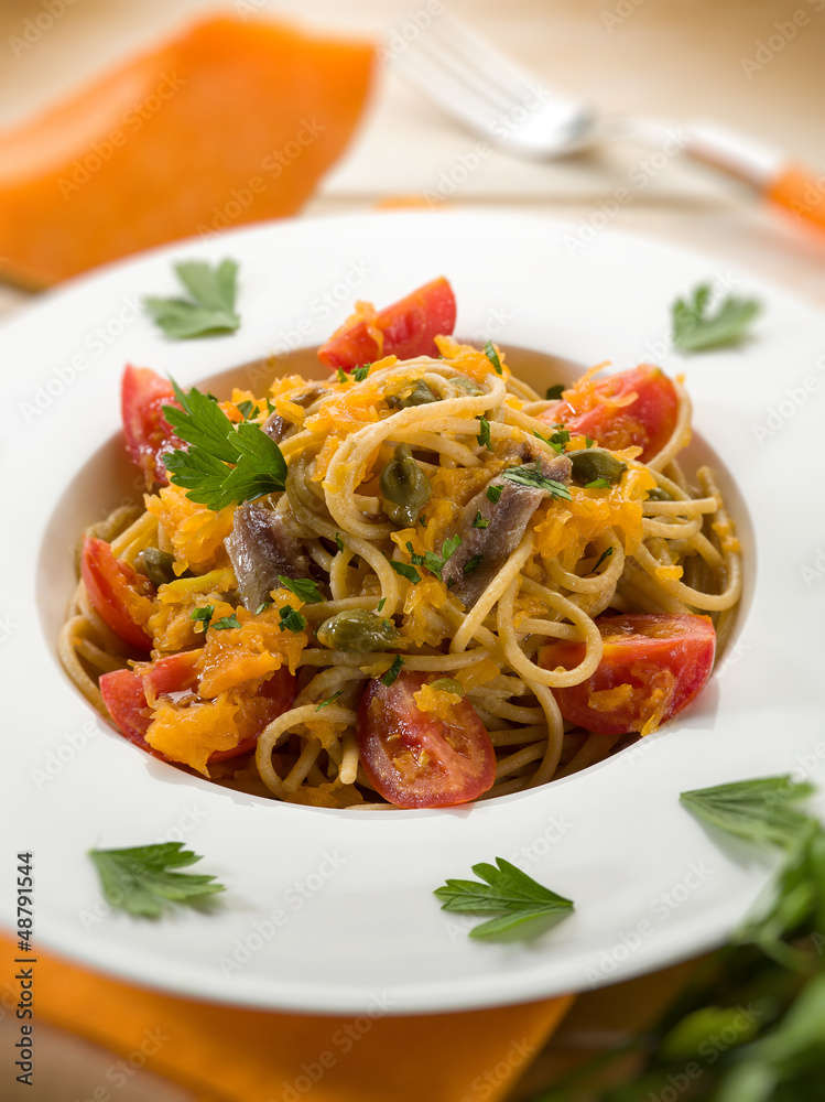 spaghetti with pumpkin anchovy caper  tomatoes, selective focus