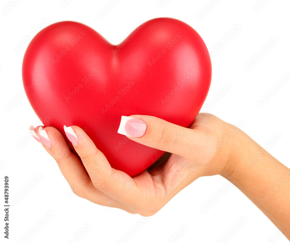 Red heart in woman's hand, on white background close-up