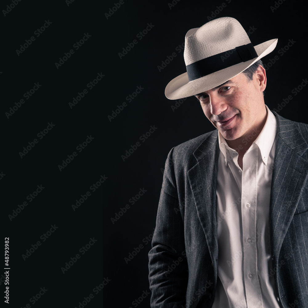 Man portrait with white hat on black background with copy space. Man portrait with white hat on black background with copy space.