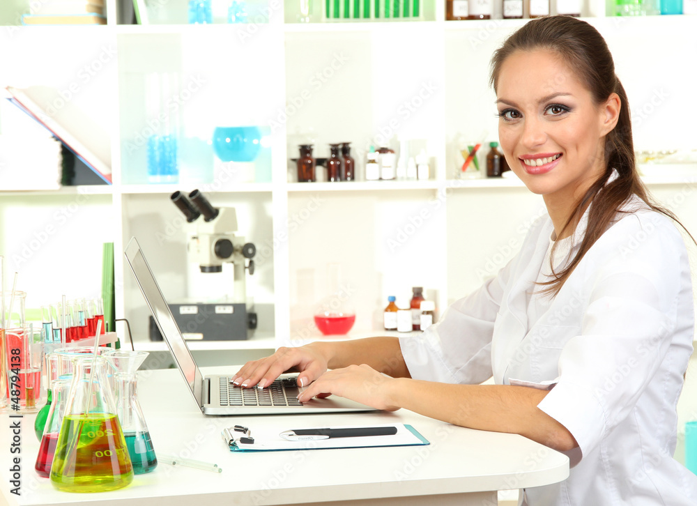 Young female scientist in laboratory. Young female scientist in laboratory.