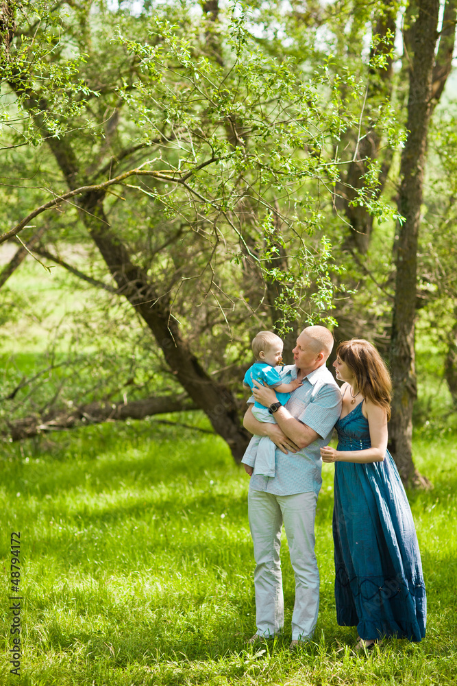 Happy family playing together in a picnic outdoors Happy family playing together in a picnic outdoors