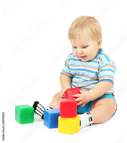 Little boy playing with multicolor blocks
