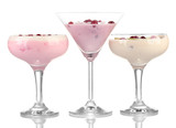 Glasses of yoghurt dessert with fruits and berries, isolated