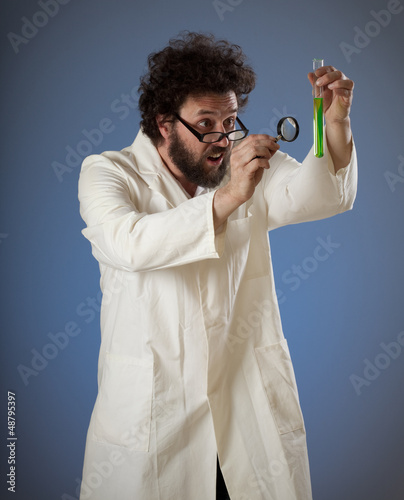 Weird scientist styudying green liquid photo