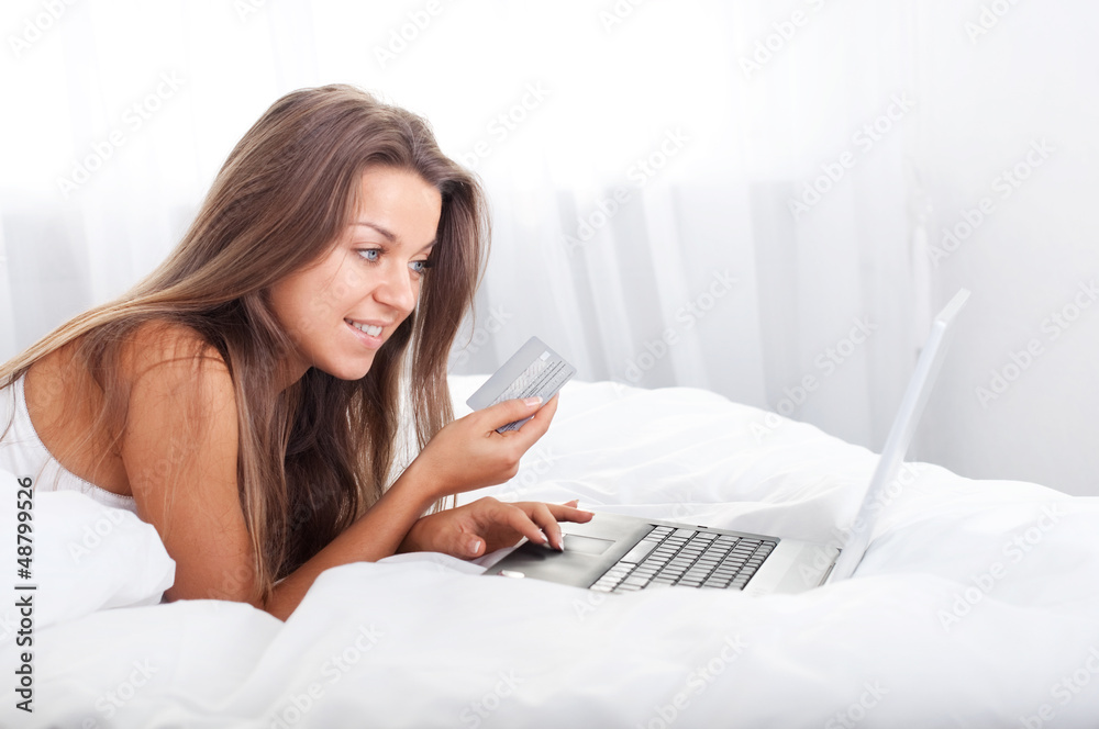 Young woman using laptop in bed Young woman using laptop in bed