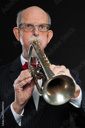 Senior jazz musician. Trumpet player. Studio shot.