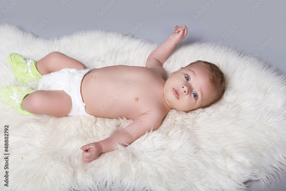 Portrait of a beautiful baby boy on fur coat background Portrait of a beautiful baby boy on fur coat background