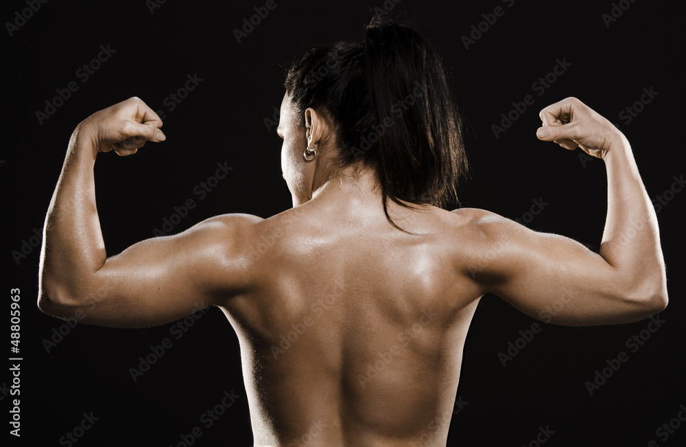 Back muscles of naked fitness woman. фотография Stock