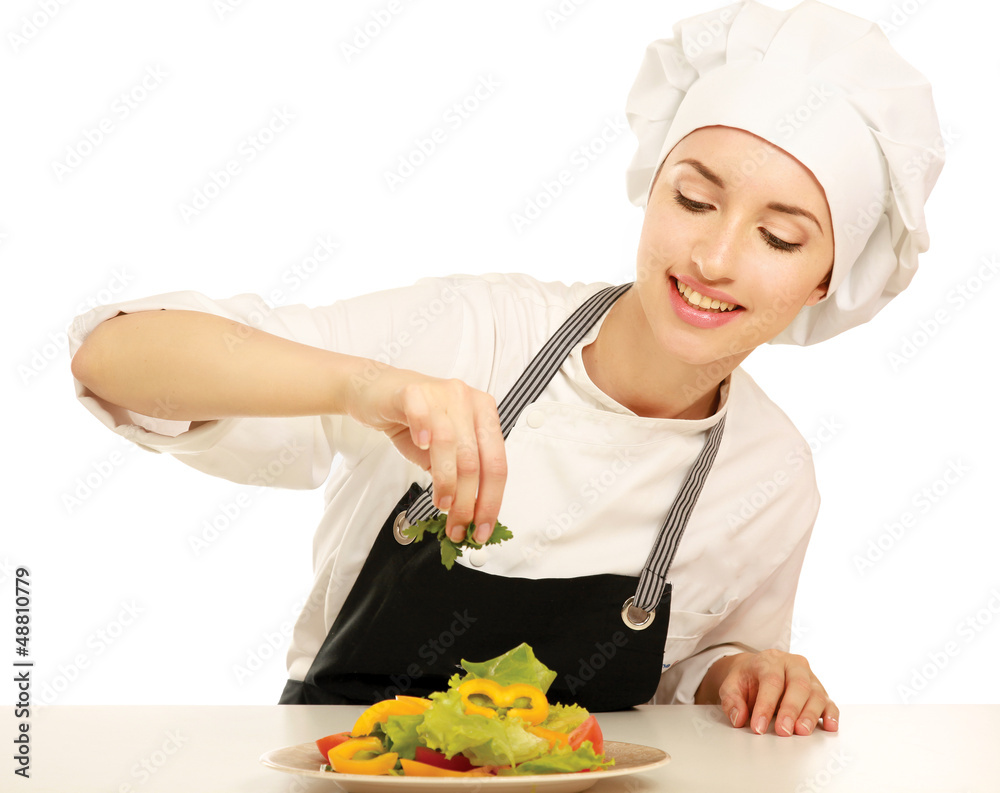 Portrait of a young cook in uniform preparing meal Portrait of a young cook in uniform preparing meal