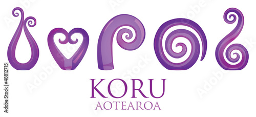 A set of purple glass Maori Koru curl ornaments.