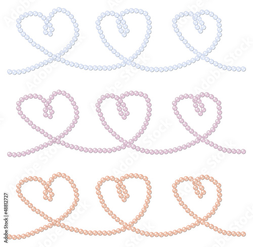 Pink, blue and lavender strings of pearls in a heart shape in ve