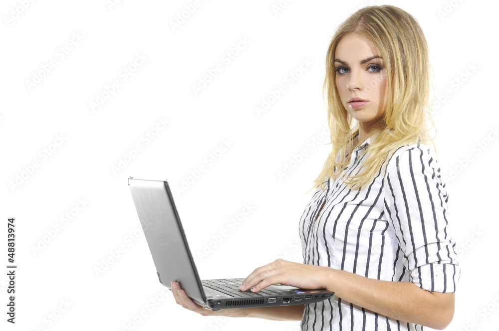 Side view of young blonde business woman standing using laptop Side view of young blonde business woman standing using laptop