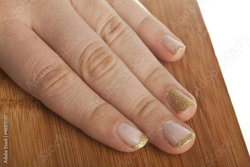 nails in gold on wooden plate