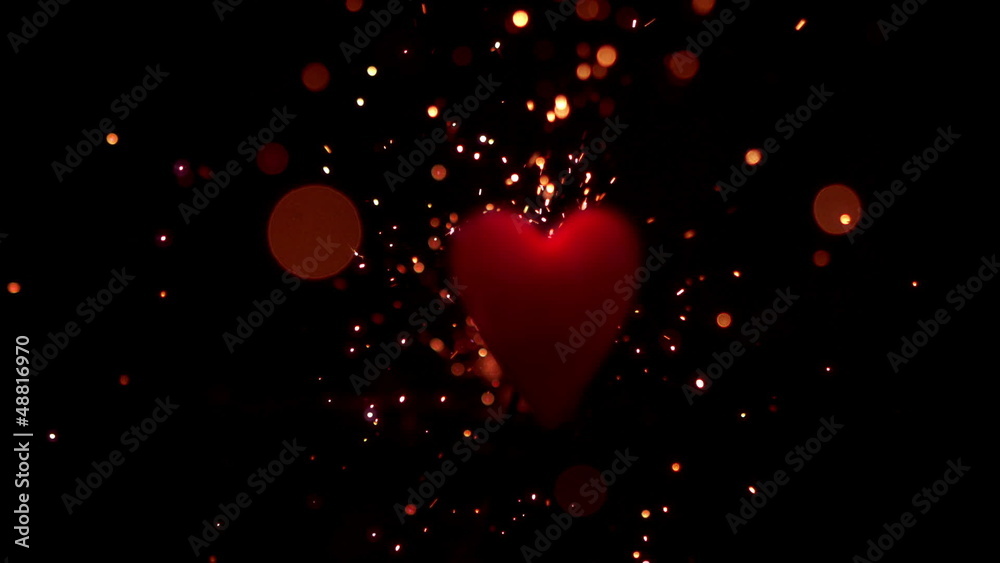 Sparks flying against pink heart Sparks flying against pink heart