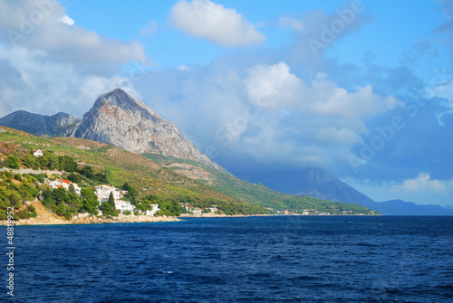 Blue Sea and a High Mountain with cloudy sky © grondetphoto