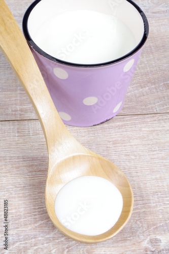 cream in wooden spoon