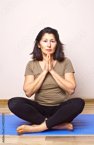 Asian woman on an mat out into a yoga position