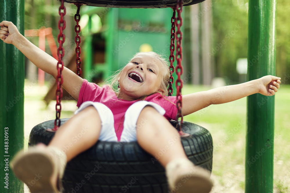 Obraz premium Happy girl having fun on playground