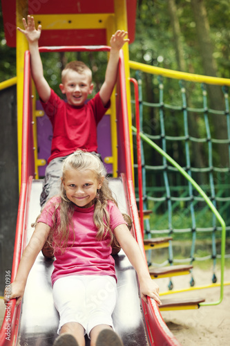 Two kids having fun on slide © gpointstudio