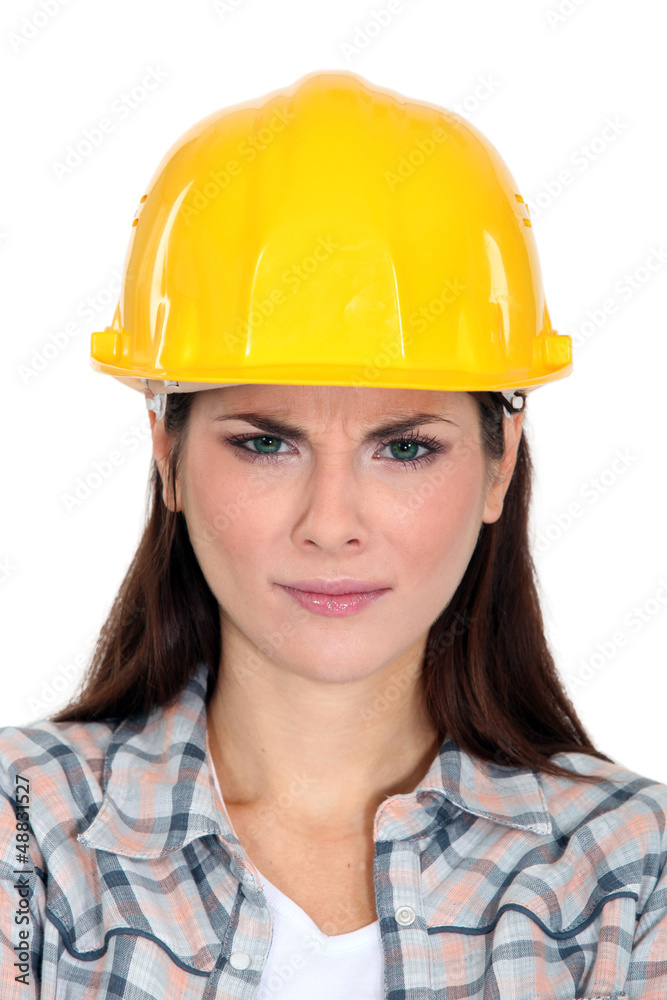 An unsatisfied female construction worker. An unsatisfied female construction worker.