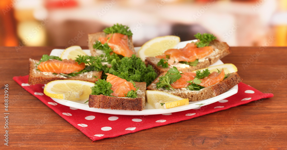 Salmon sandwich on plate,on bright background Salmon sandwich on plate,on bright background