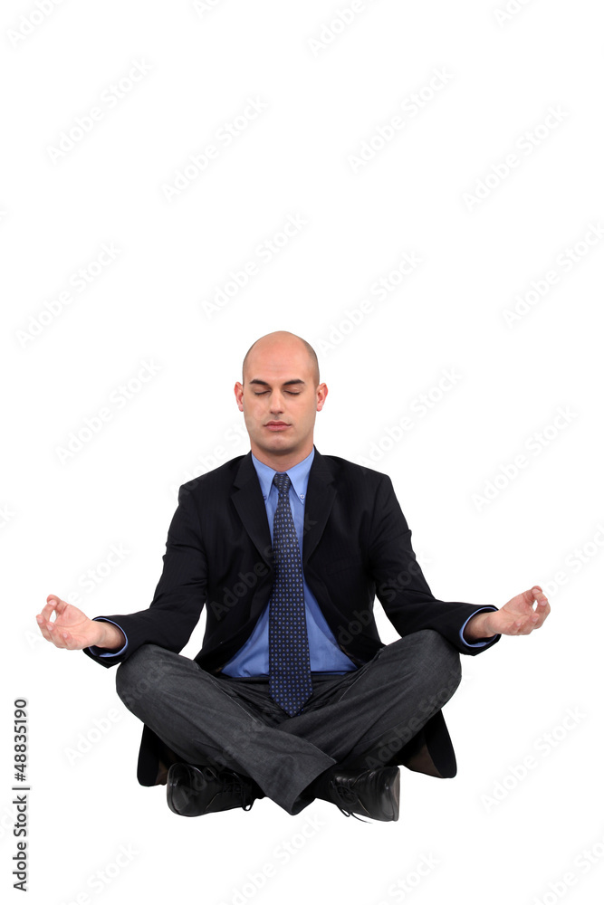 Businessman in a yoga position Businessman in a yoga position