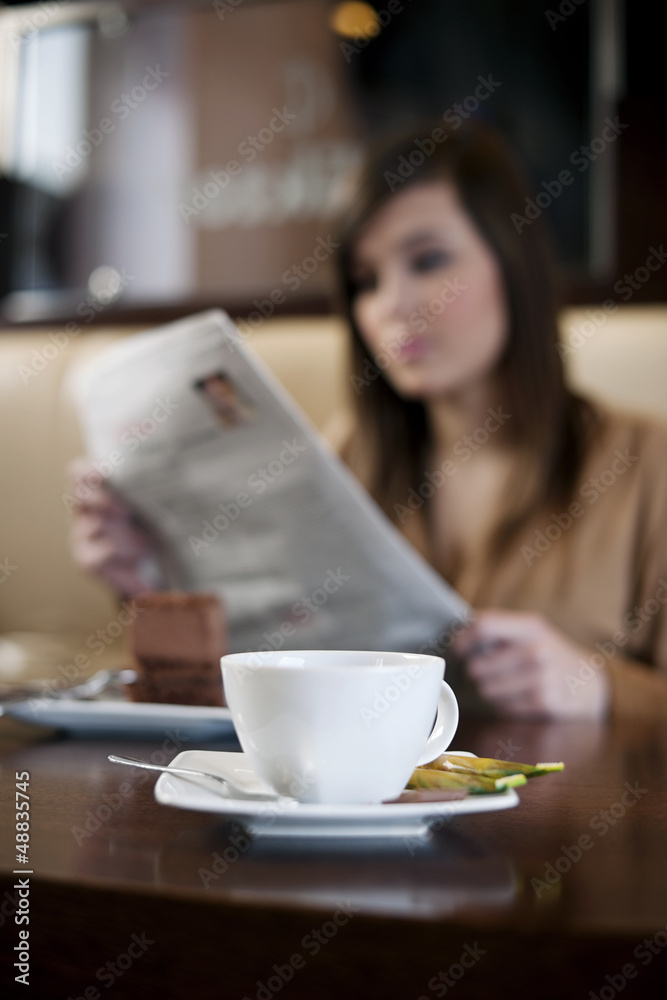 Reading newspaper in cafe Reading newspaper in cafe